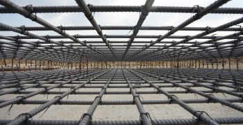 A deformed steel bars frame inside concrete footing or floor.