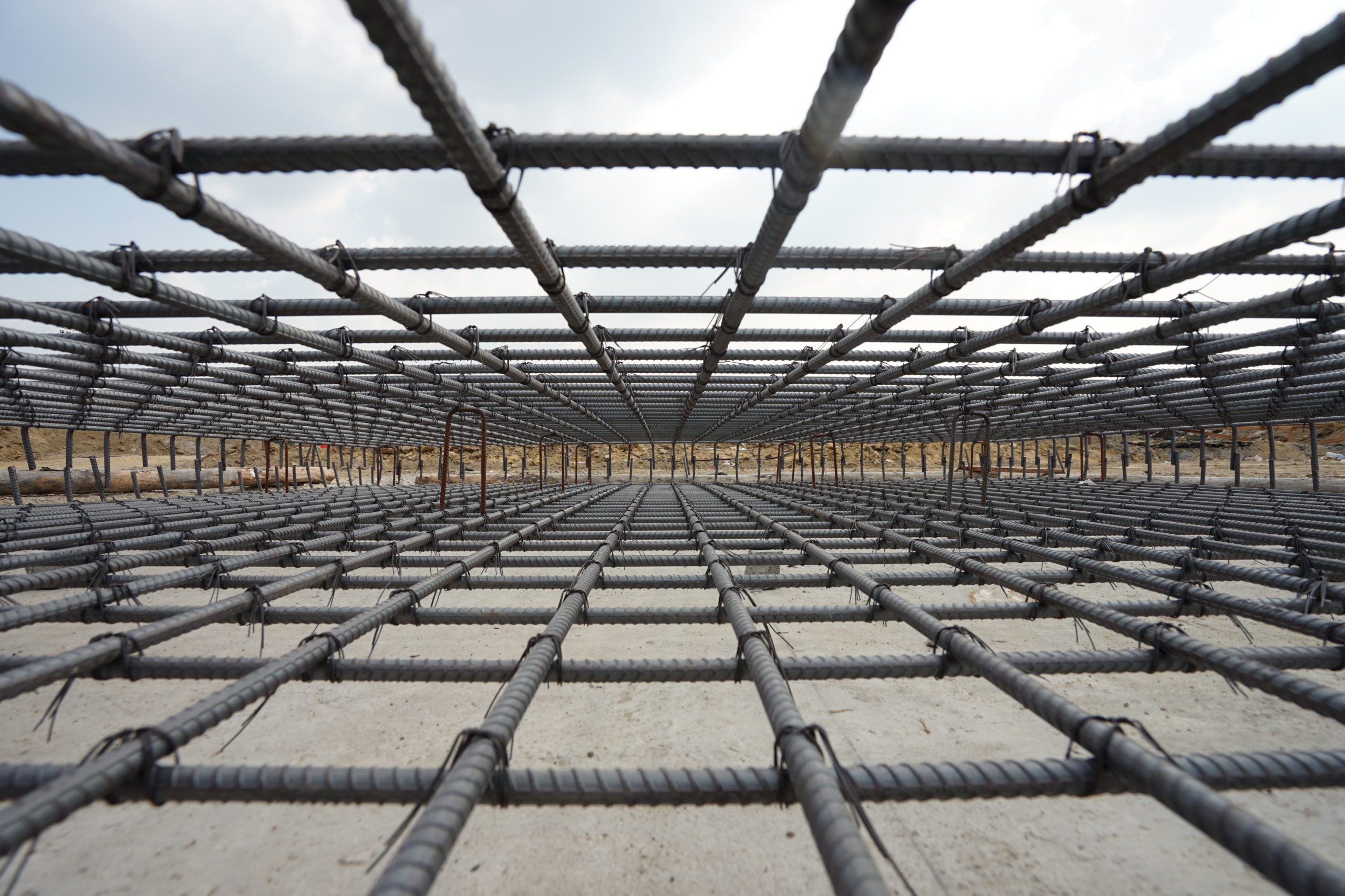 A deformed steel bars frame inside concrete footing or floor.